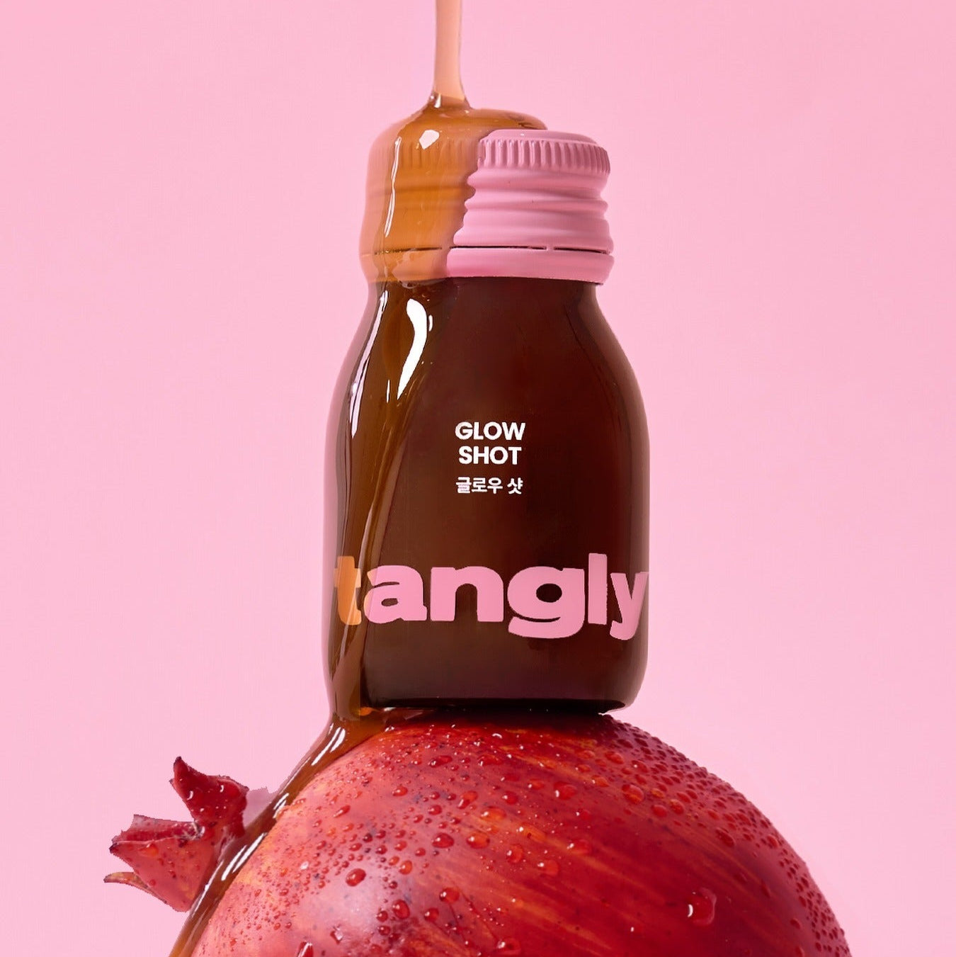 NOTHING BETTER Tangly Glow Shot 7 Bottles featuring a vibrant design with pomegranate on a pink background.