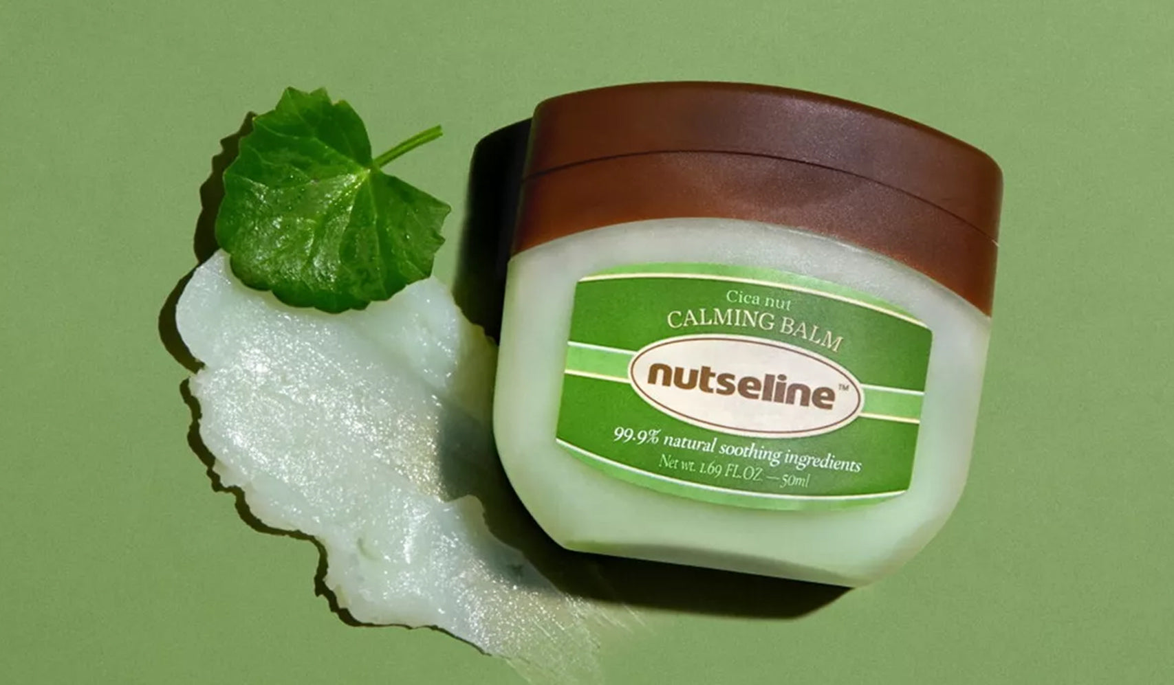 Calming balm product by Nutseline with natural soothing ingredients, displayed on a green background with leaf and balm texture.