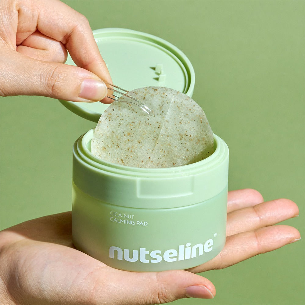 Person holding a NUTSELINE Cica Calming Pad container with open lid and visible calming pad inside.