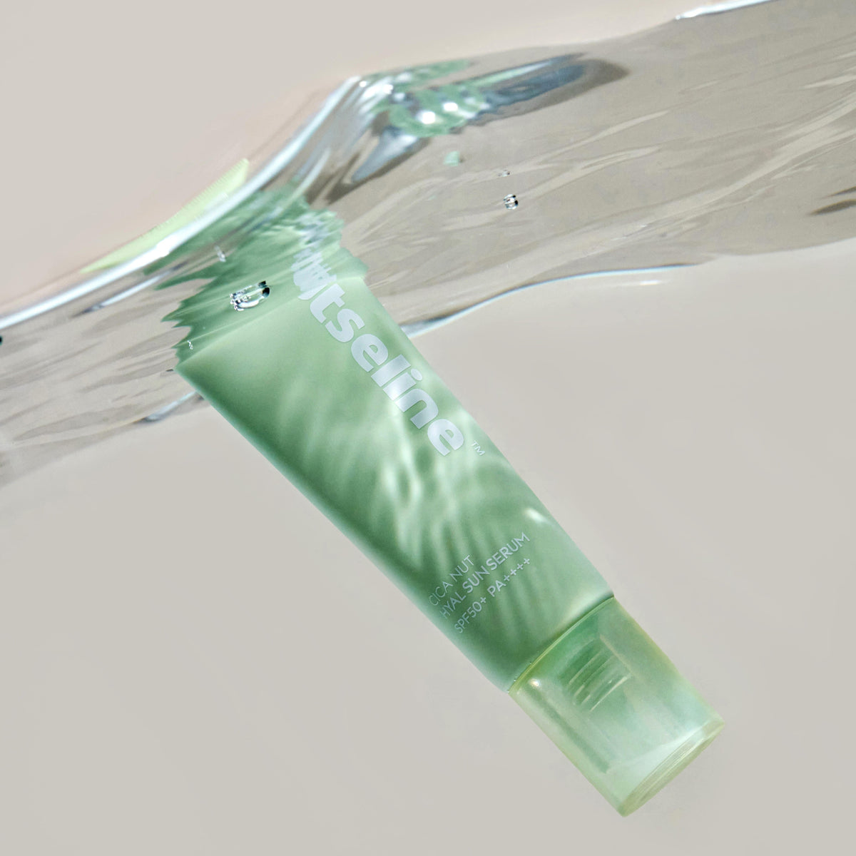 NUTSELINE Cica Nut Hyal Sun Serum 50ml submerged in water, showcasing the product's waterproof properties.