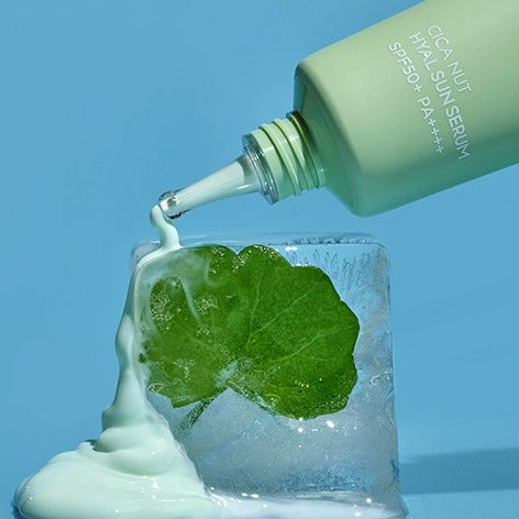 NUTSELINE Cica Nut Hyal Sun Serum 50ml serum pouring onto leaf on ice with SPF 50+ for sun protection.