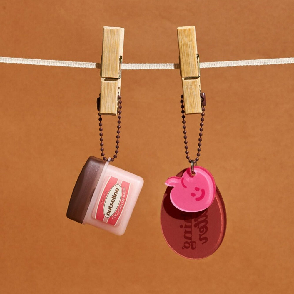 NUTSELINE Super Nut Collagen Keyring Lip Balm 11ml hanging on line with keyring attached
