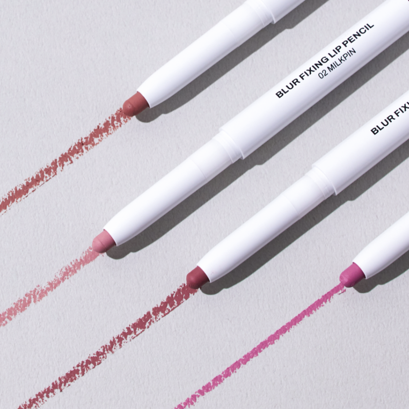 OIAD Blur Fixing Lip Pencil displayed in various shades on a neutral background