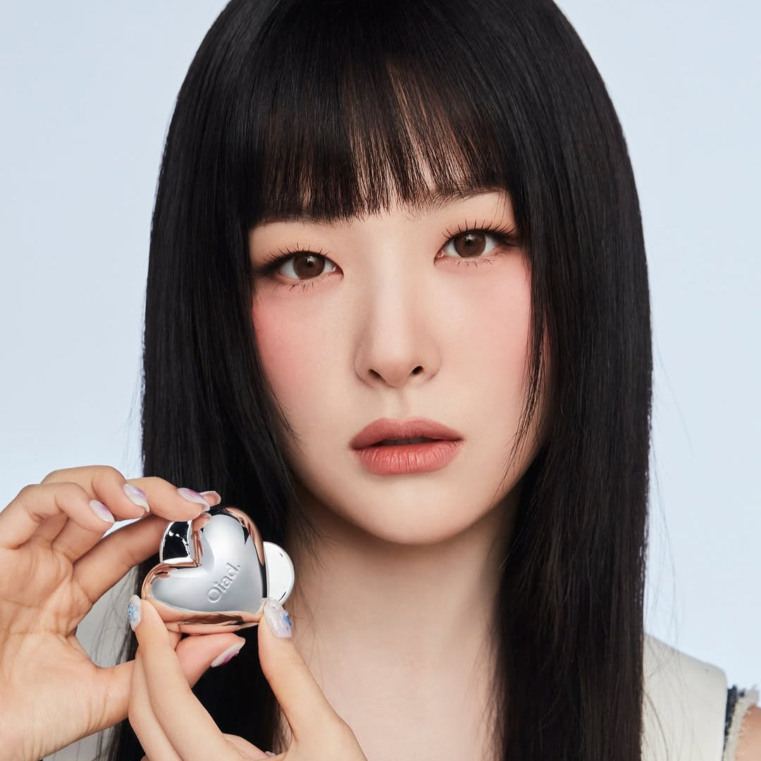 Model holding OIAD Silverpulse Moussecream Lip&Cheek product, showcasing dual-use lip and cheek makeup in heart-shaped packaging.