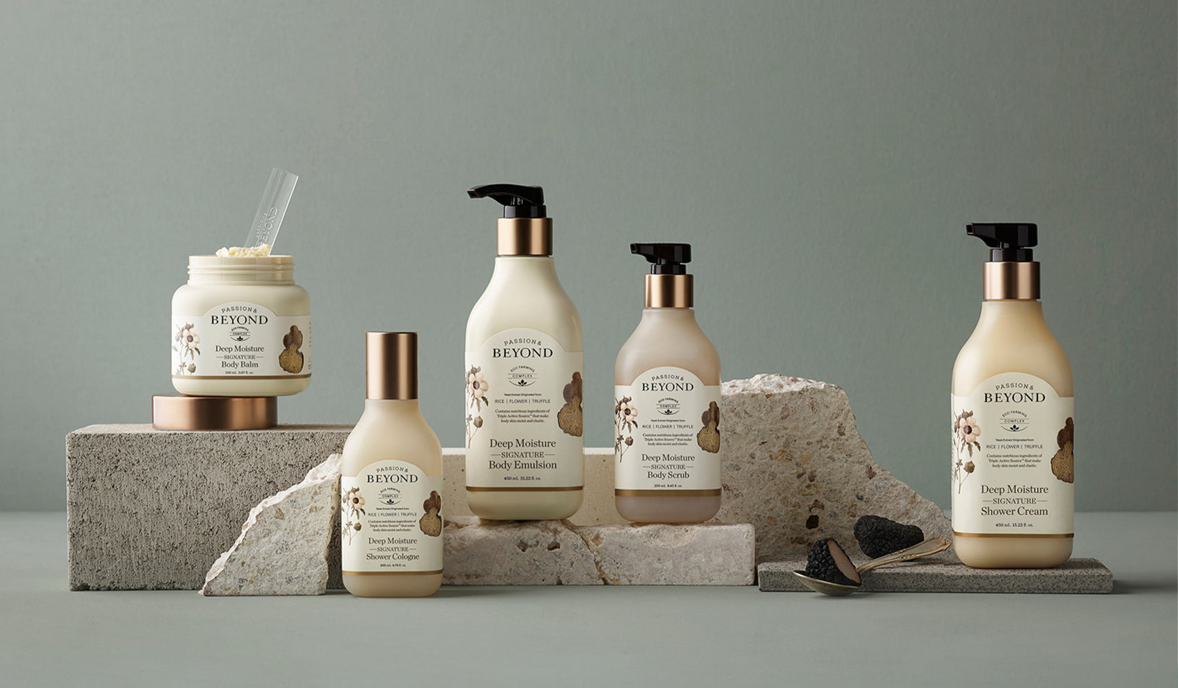 Collection of Beyond body care products including lotions and creams displayed on stone platforms.