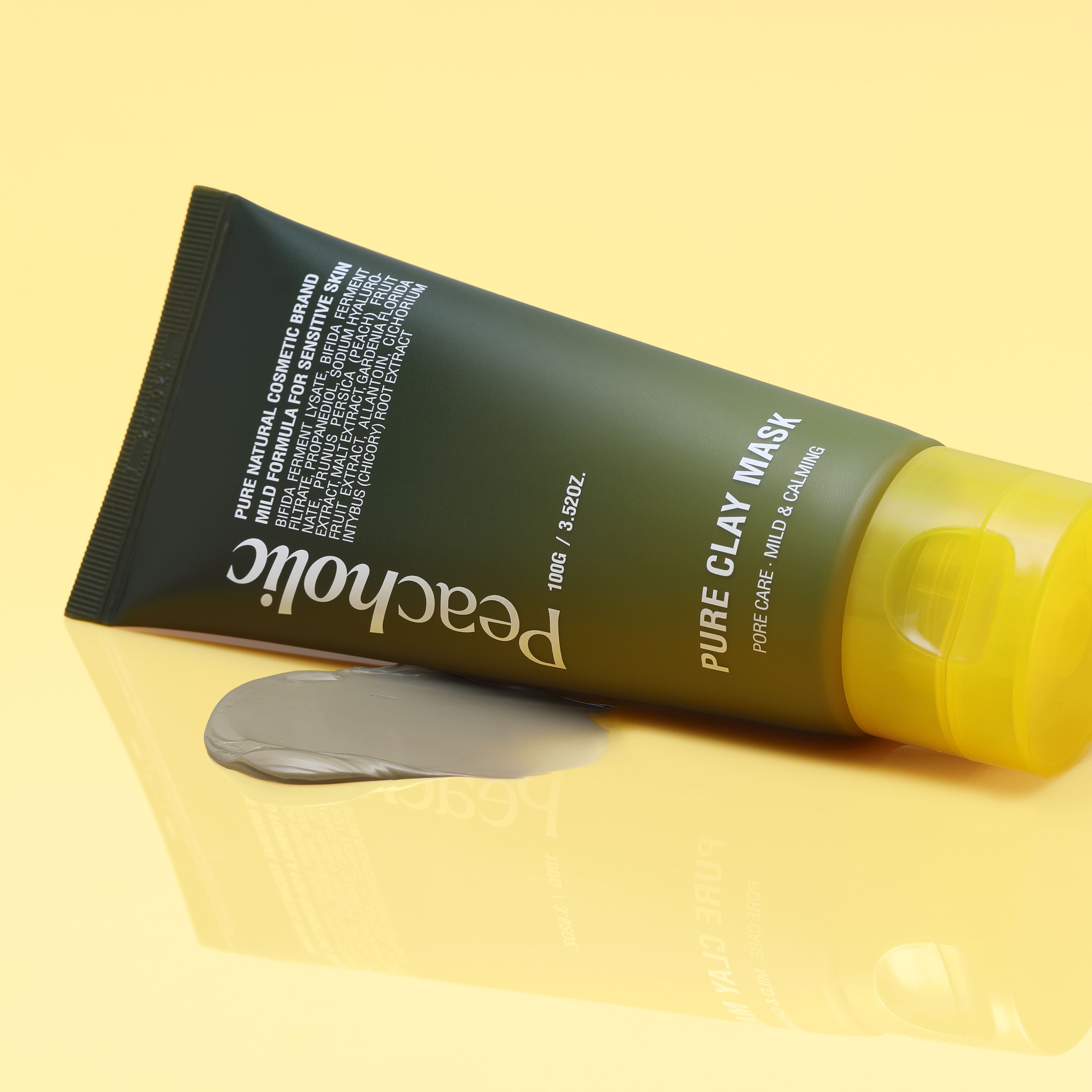 PEACHOLIC Pure Clay Mask 100ml tube with mask smear on yellow background.