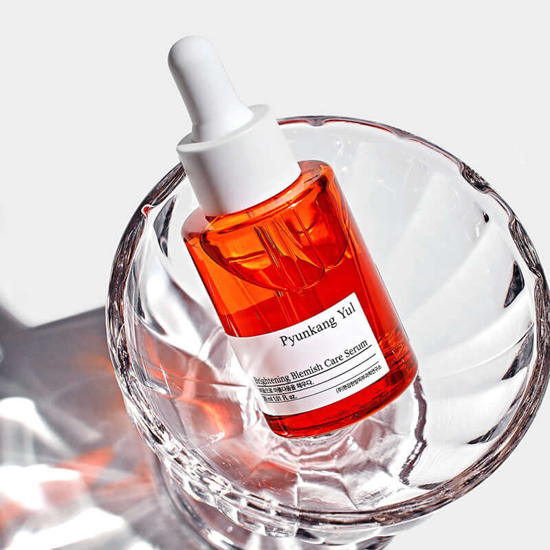 PYUNKANG YUL Brightening Blemish Care Serum 30ml in a clear glass dish with white background