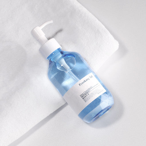 Bottle of PYUNKANG YUL Low pH Cleansing Oil 290ml on a white towel.
