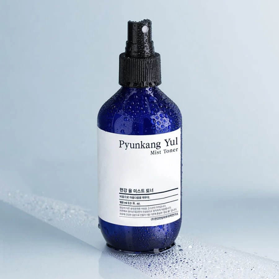 PYUNKANG YUL Mist Toner 200ml bottle with water droplets on a smooth surface.