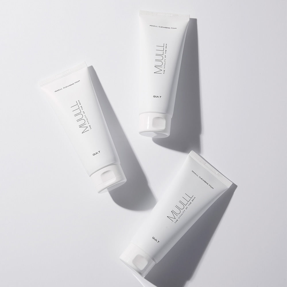 Three tubes of QUA-T Cleansing foam 150g on a white background.