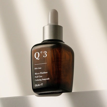 QUA-T Dia Nano Emulsion Full Cica Soothing Ampoule 30ml bottle in sunlight, highlighting skincare product design and details.