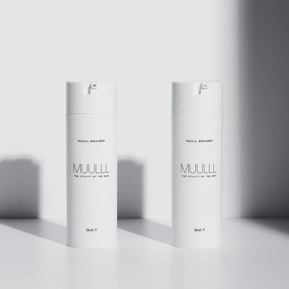 Two bottles of QUA-T Emulsion 150ml placed side by side in bright lighting against a white background.