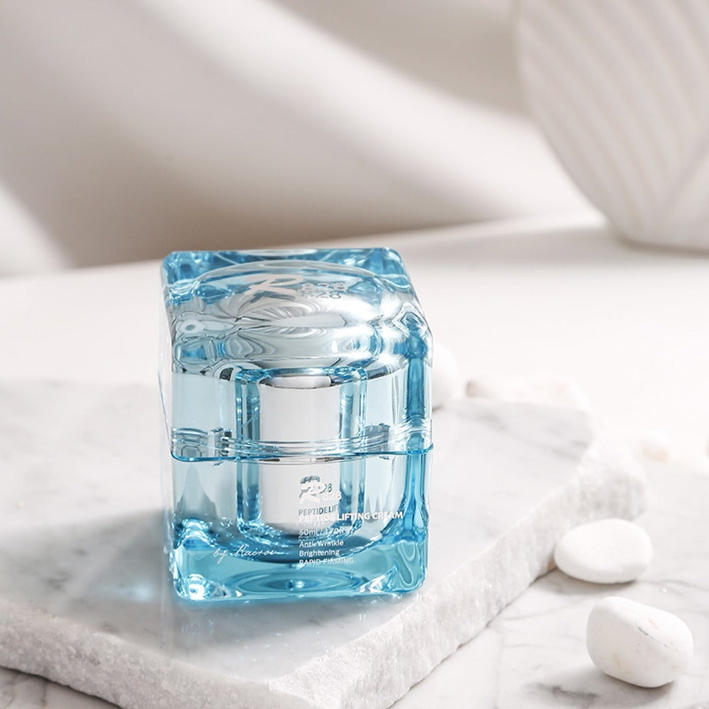 R828 Peptide Lifting Cream in elegant glass container on marble surface, skincare product
