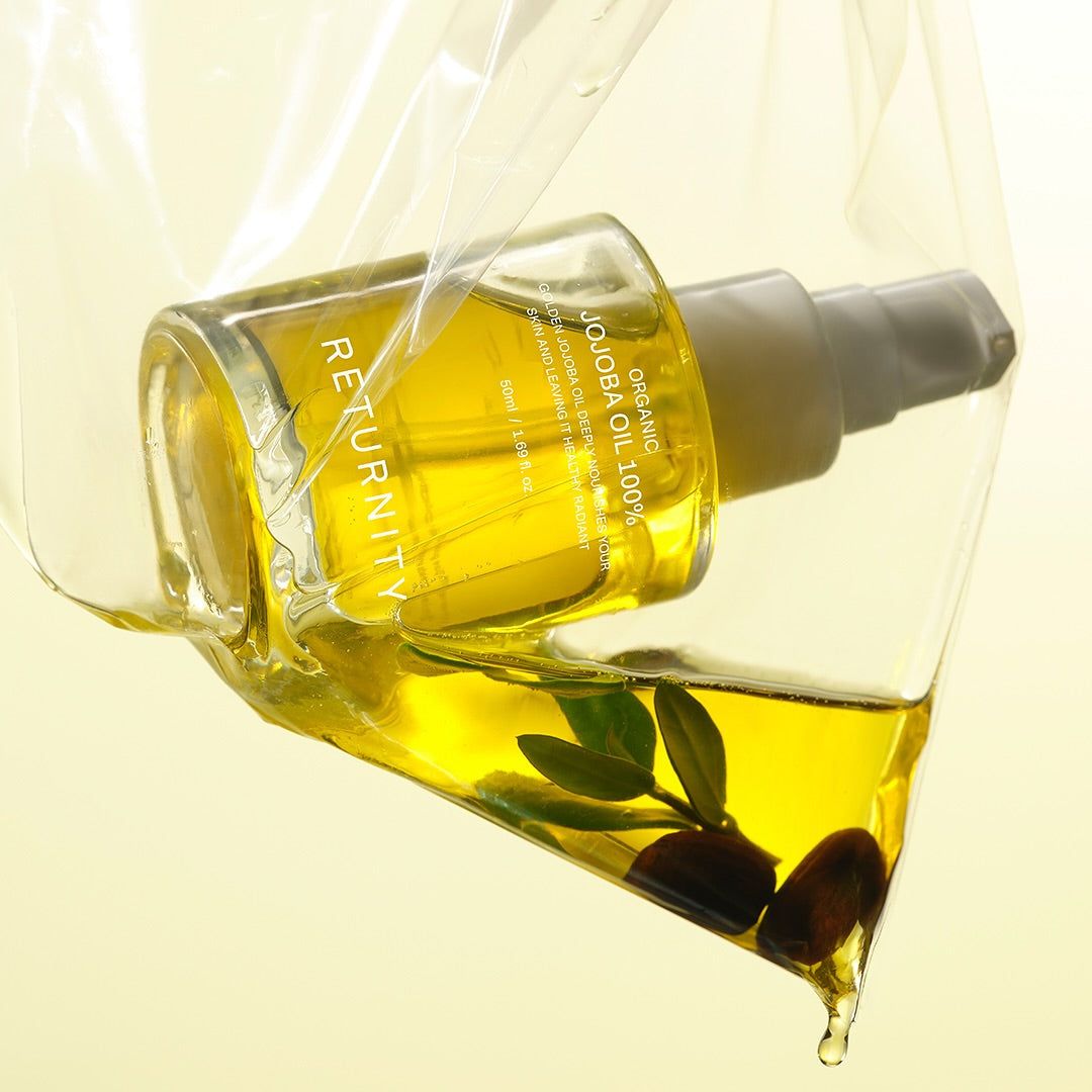 RETURNITY Organic Jojoba Oil 100% 50ml in a clear dispenser against a yellow background