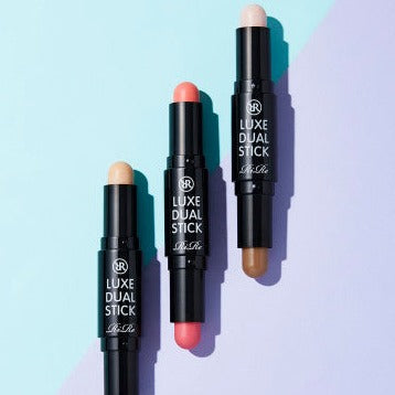 Three shades of RIRE Luxe dual Stick makeup on a pastel background highlighting versatile cosmetic options.