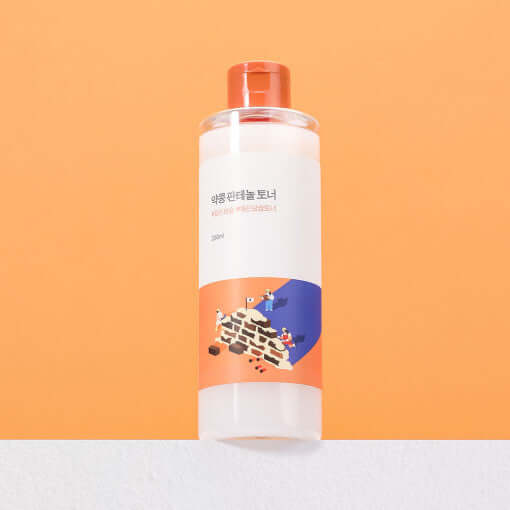 ROUND LAB Yakkong Panthenol Toner 250ml bottle on an orange background, skincare product for soothing and moisturizing.