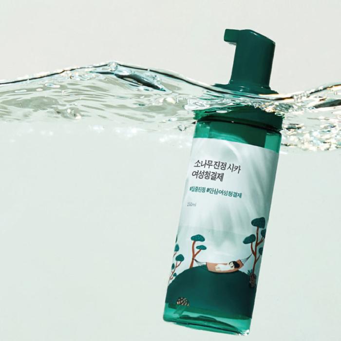 ROUNDLAB Pine Calming Cica Feminine Cleanser 150ml bottle partially submerged in water