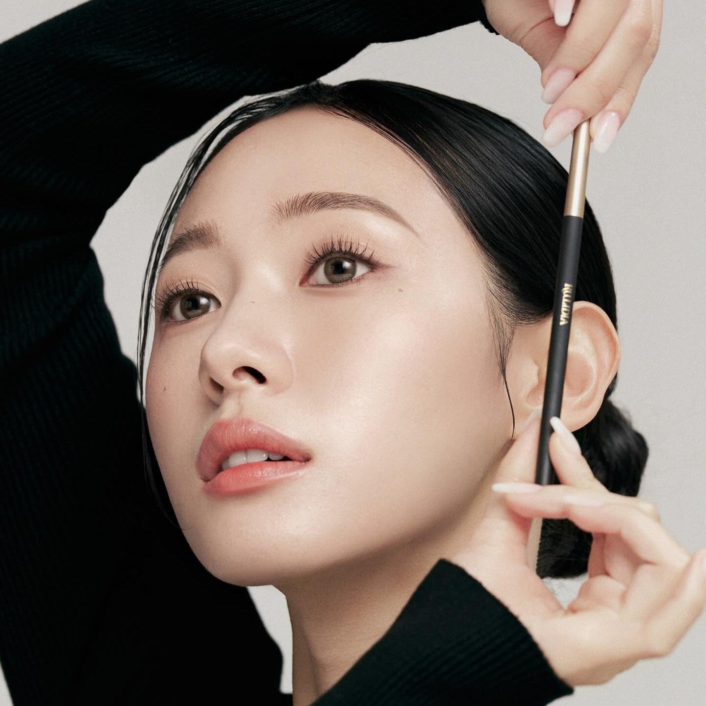 Woman using RULIDIA Easy Detail Brow pencil for precise eyebrow styling and shaping.