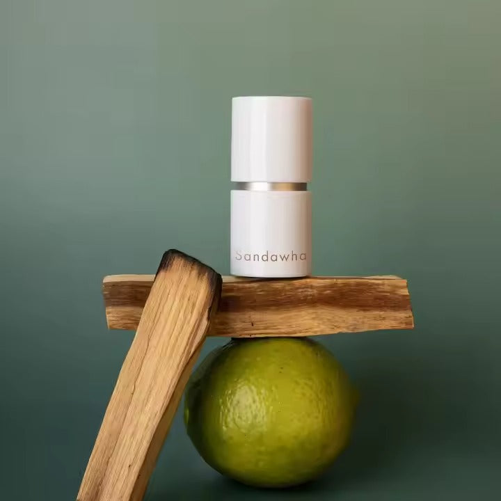 SANDAWHA Remember Perfume Balm 5.6g showcased with a natural backdrop including wood and a green lime.