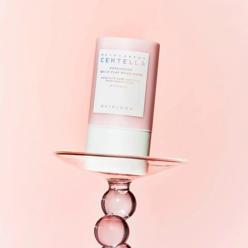 SKIN1004 Madagascar Centella Poremising Quick Clay Stick Mask 27g on display against a pink background
