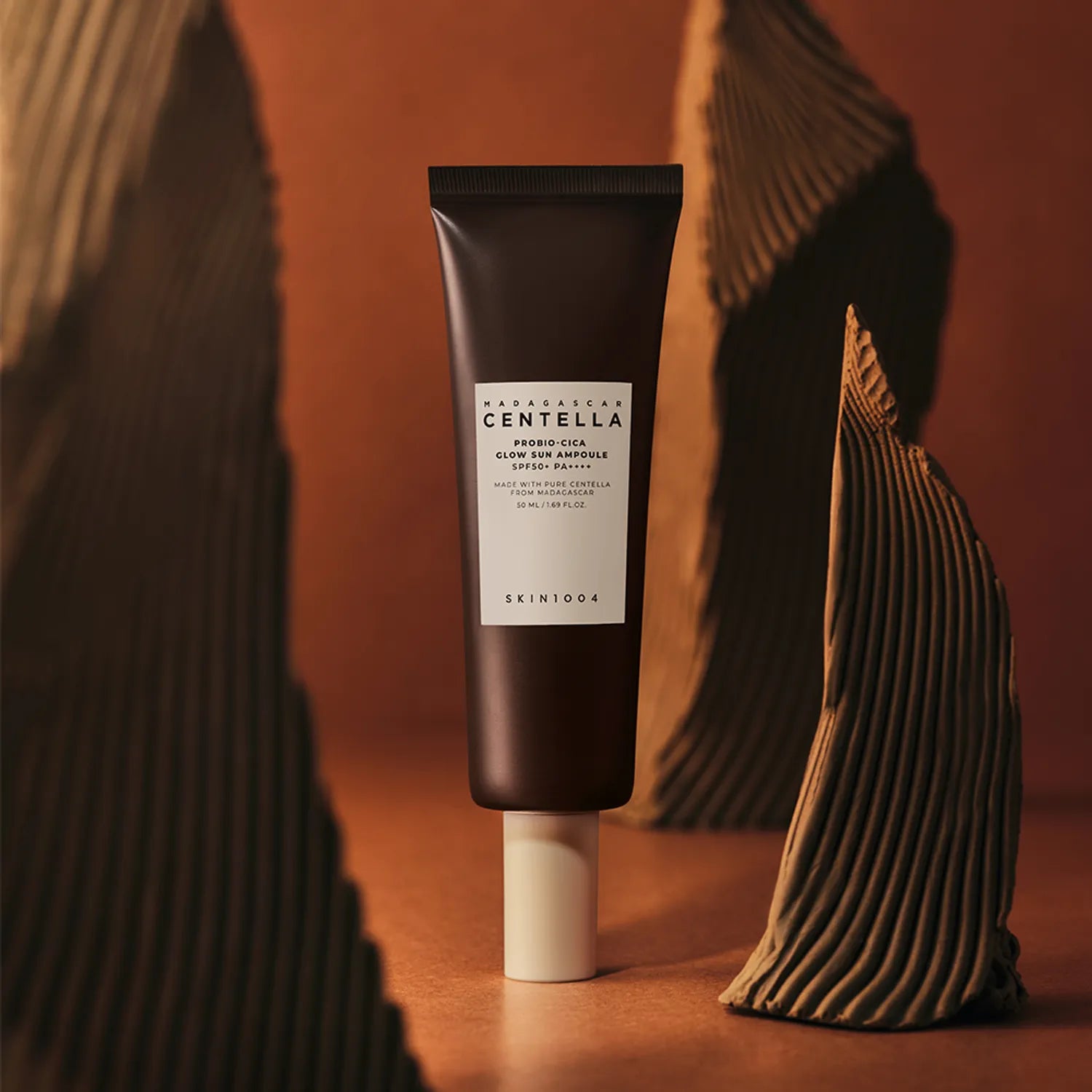 SKIN1004 Madagascar Centella Probio-cica Glow Sun Ampoule 50ml against artistic background