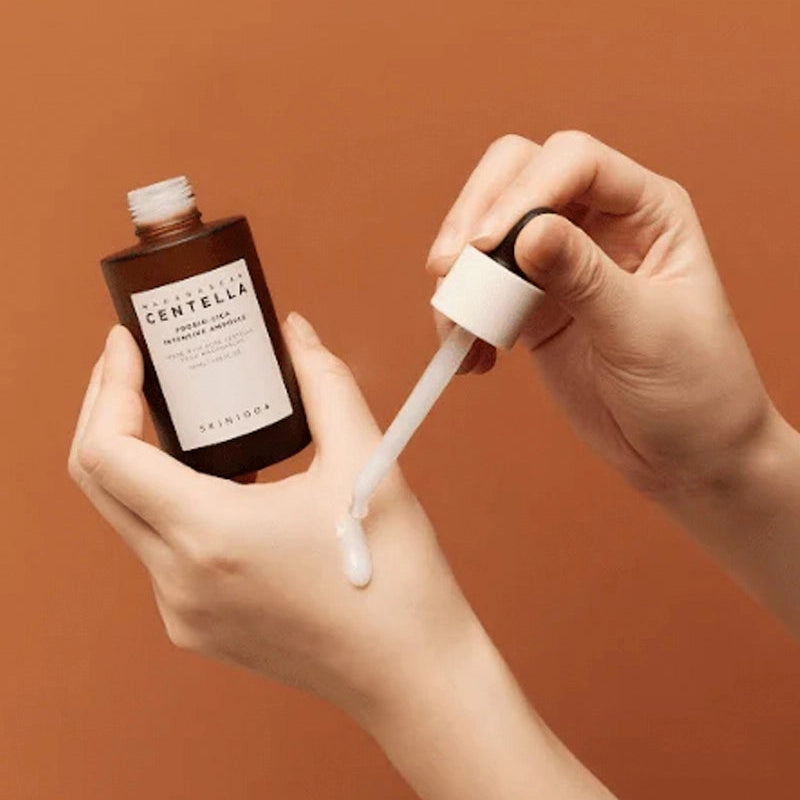 Applying SKIN1004 Madagascar Centella Probio-cica Intensive Ampoule 50ml on skin with dropper.