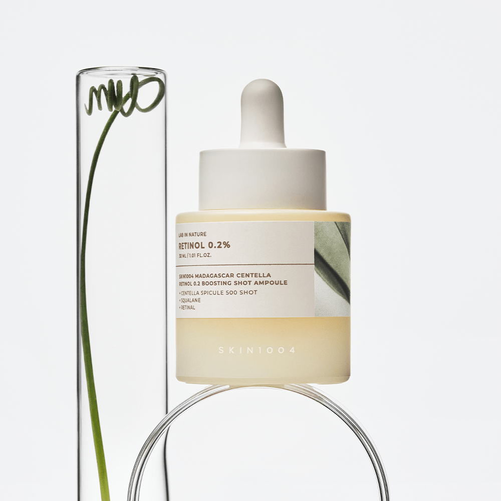 SKIN1004 Madagascar Centella Retinol 0.2 Boosting Shot Ampoule 30ml displayed beside a clear glass tube with a leaf.