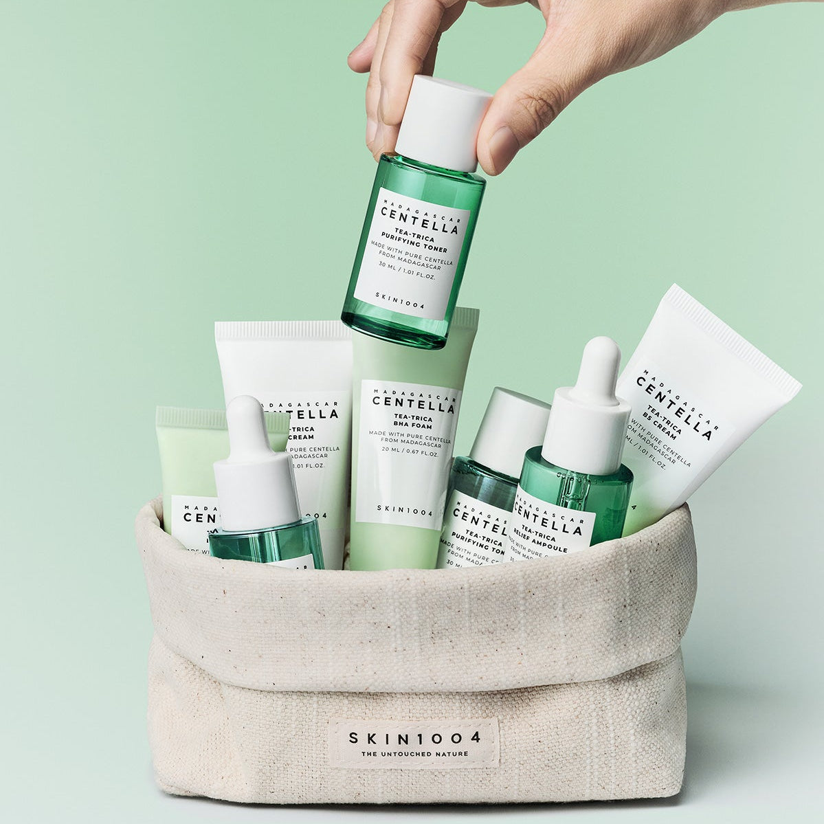 SKIN1004 Madagascar Centella Teatrica Travel Kit products in a pouch with green background