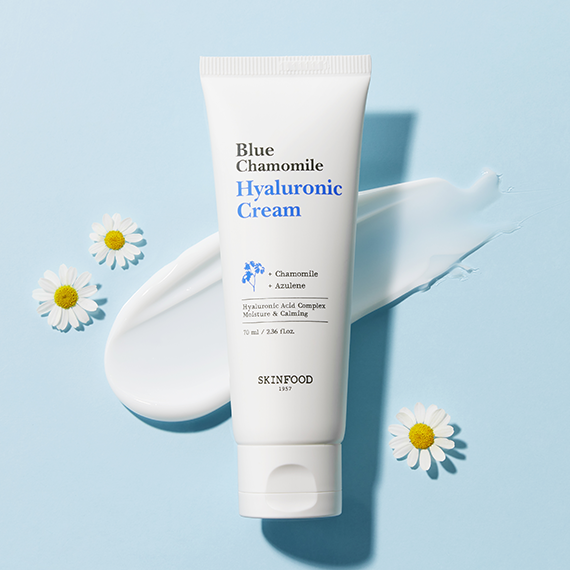 SKINFOOD Blue Chamomile Hyaluronic Cream 70ml with chamomile flowers on blue background