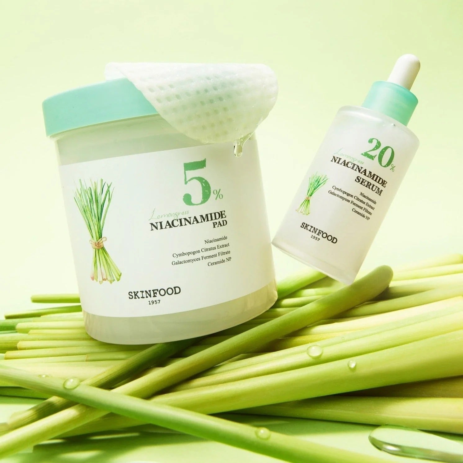 SKINFOOD Lemongrass Niacinamide 5 60 Pads next to serum bottle on lemongrass stalks