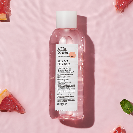 SKINFOOD Pink Grapefruit AHA Toner 200ml bottle with pink grapefruit slices on a pink background