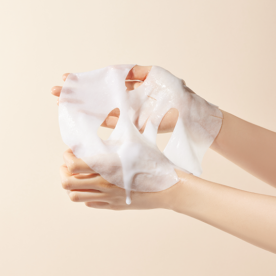 Hands holding SKINFOOD Rice Brightening Sheet Mask 10 sheets with rice extract essence for skin brightening and hydration.