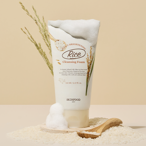 SKINFOOD Rice Daily Brightening Cleansing Foam 150ml product image with foam and rice background.