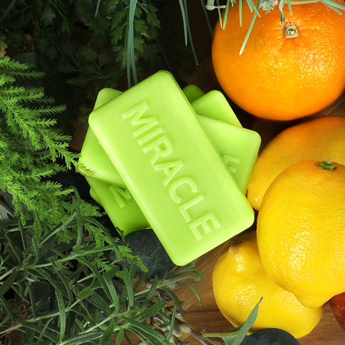 SOME BY MI AHA.BHA.PHA miracle cleansing bar surrounded by citrus fruits and green leaves, showcasing natural ingredients for skincare.