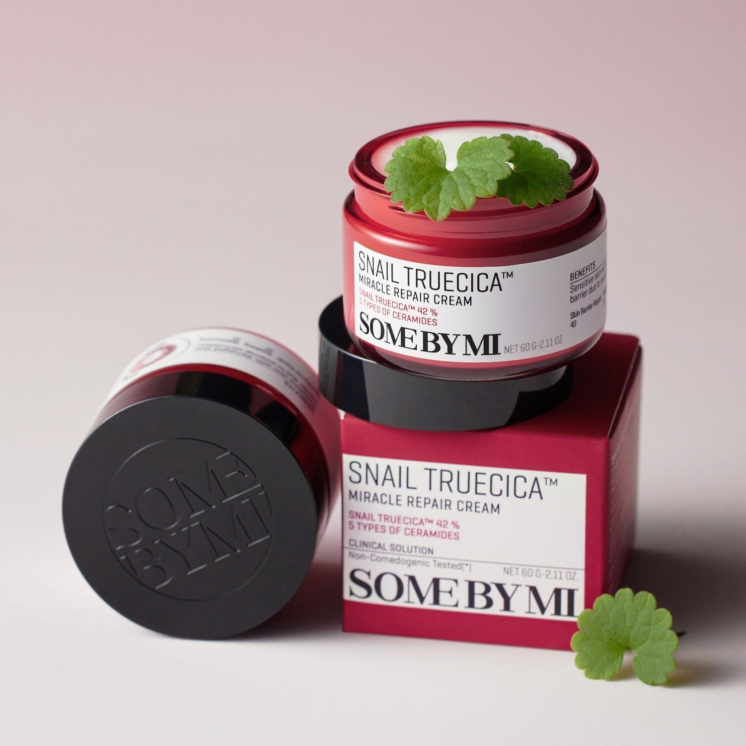 SOME BY MI Snail Truecica Miracle Repair Cream 60g open jar on red box with plant leaves, enhancing skin rejuvenation and repair.