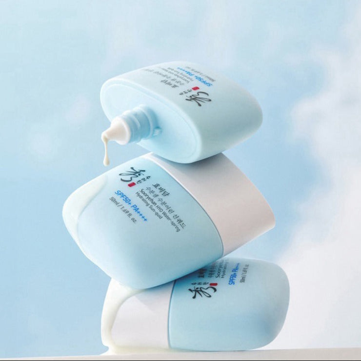 SOORYEHAN HYO Water-Spring Hydrating Sun-quid 50ml bottles stacked against a sky background