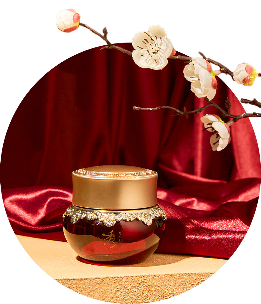 SOORYEHAN Hyobidam Fermented Eye Cream 25ml jar on red satin with cherry blossoms in background.