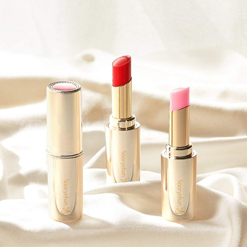 SOORYEHAN Yeon Silk Lip Balm 3.5g in elegant gold casing on a soft fabric background.