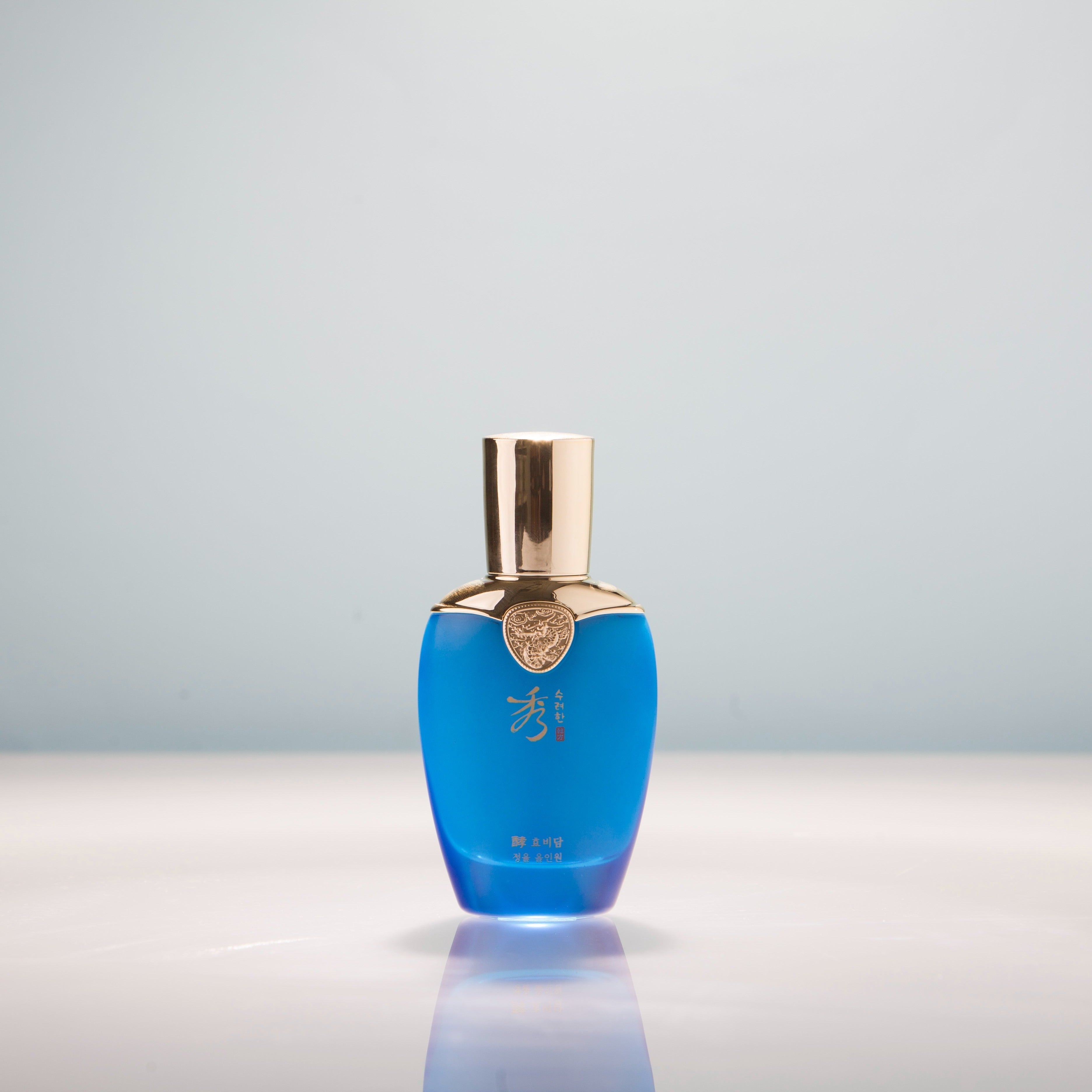 SOORYEHAN Hyobidam Jeongyul All-in-One 100ml blue bottle on a reflective surface.