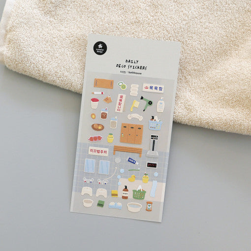 Sheet of SUATELIER Bathhouse Stickers with various bath-themed designs lying on a towel.