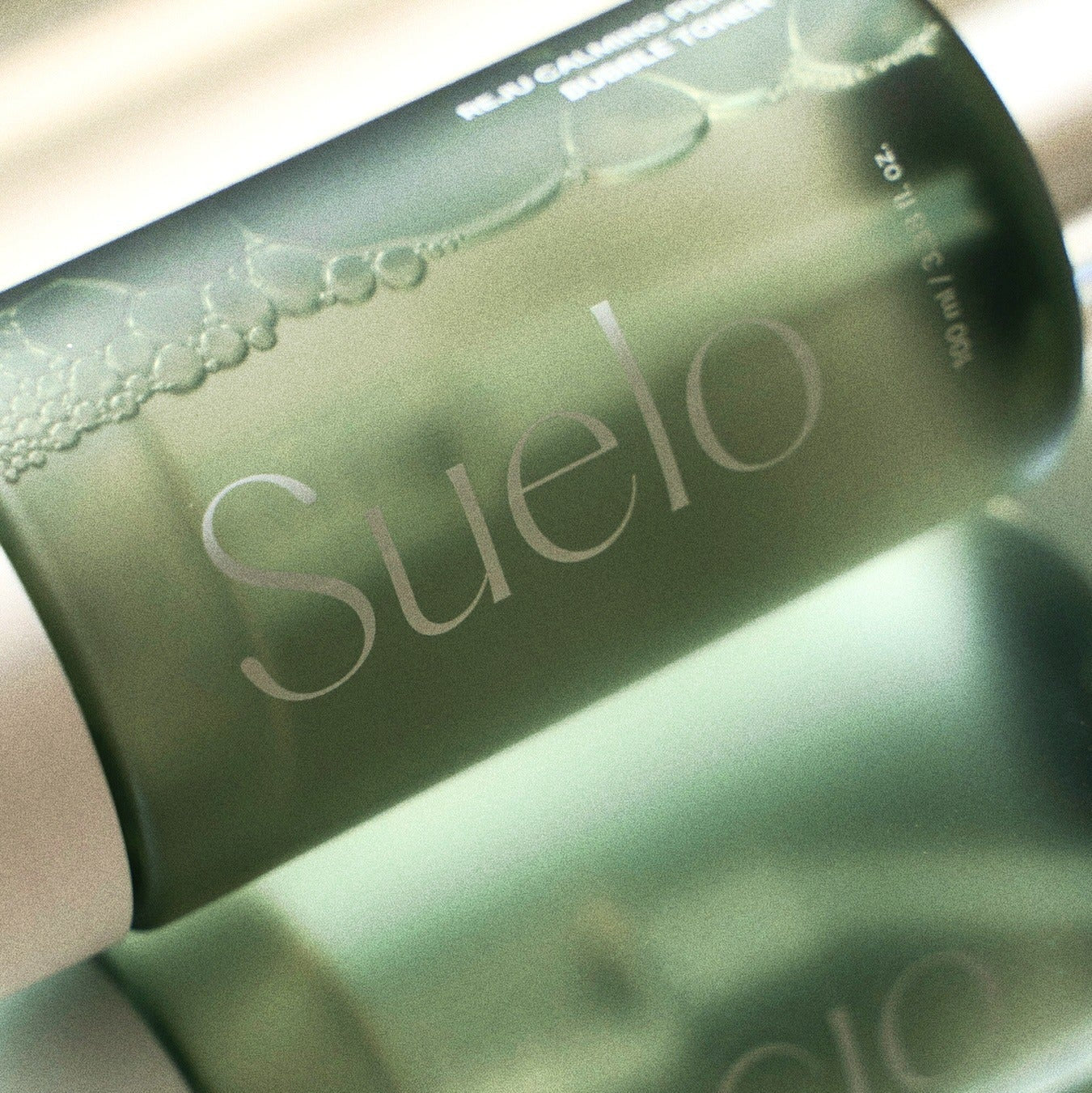 SUELO Reju Calming PDRN Bubble Toner 100ml bottle with bubbles, designed for soothing and rejuvenating skincare, 100ml size.