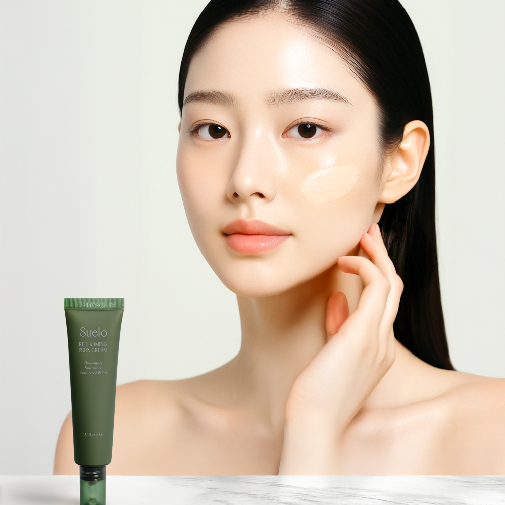 Woman applying SUELO Reju Calming PDRN Cream 30ml to her cheek for a soothing effect.