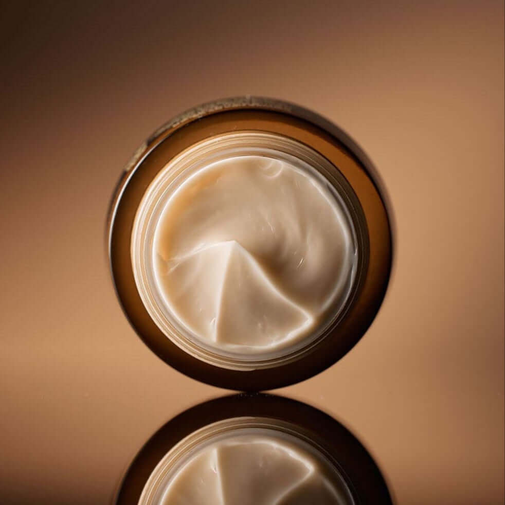 Open jar of SU:M37 Fermentalift Rejuvenating Eye Cream 25ml showcasing rich, creamy texture ideal for anti-aging skincare.