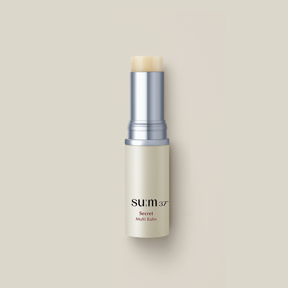 SU:M37 Secret Multi Balm 7g displayed on a beige background, highlighting its sleek design and compact size.