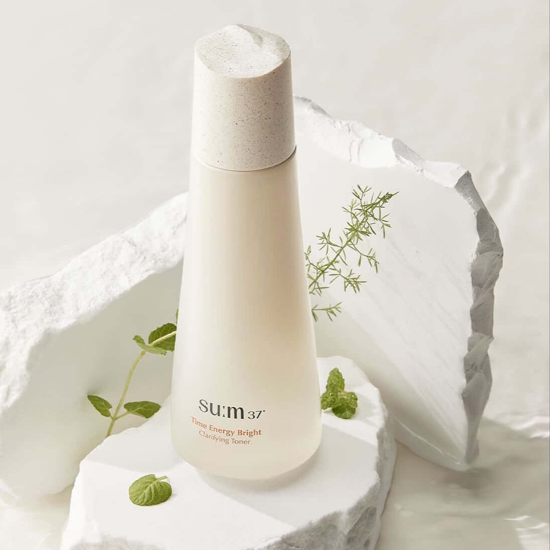 SU:M37 Time Energy Bright Clarifying Toner 170ml bottle with natural herbs on white background