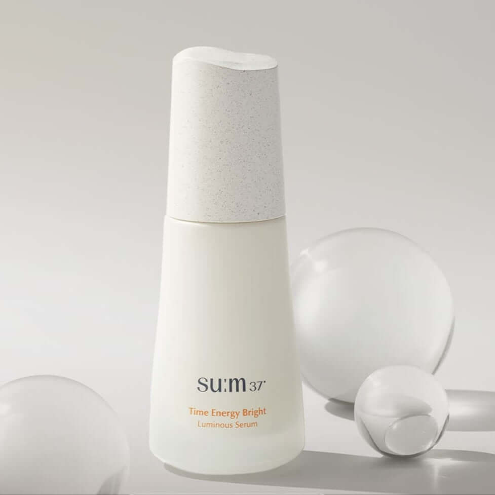 SU:M37 Time Energy Bright Luminous Serum 50ml displayed with decorative bubbles
