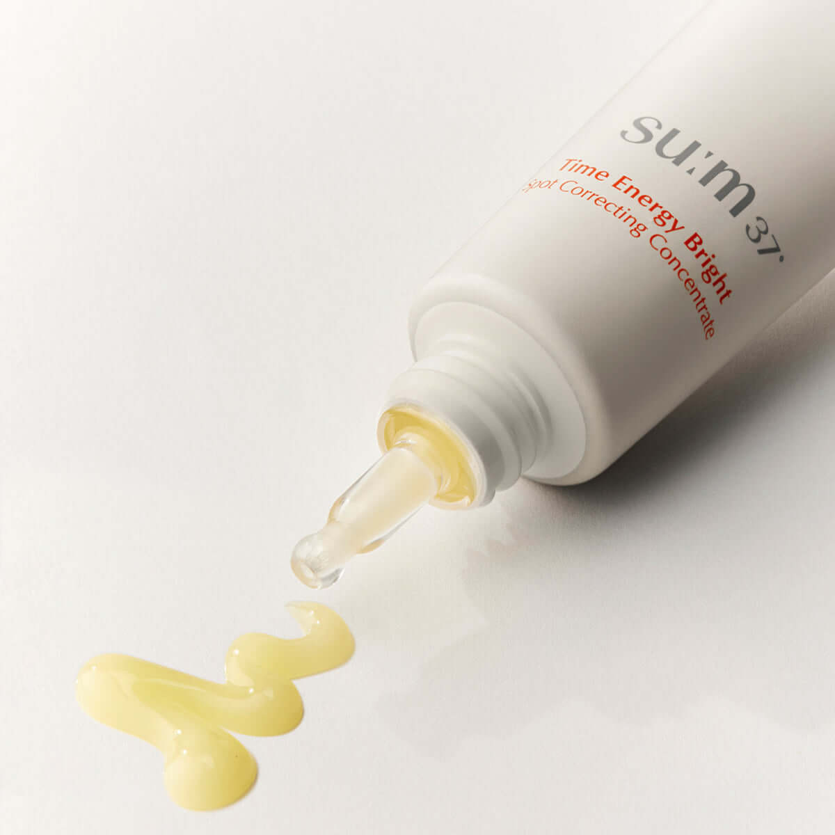 SU:M37 Time Energy Bright Spot Correcting Concentrate 35ml bottle spilling on white surface
