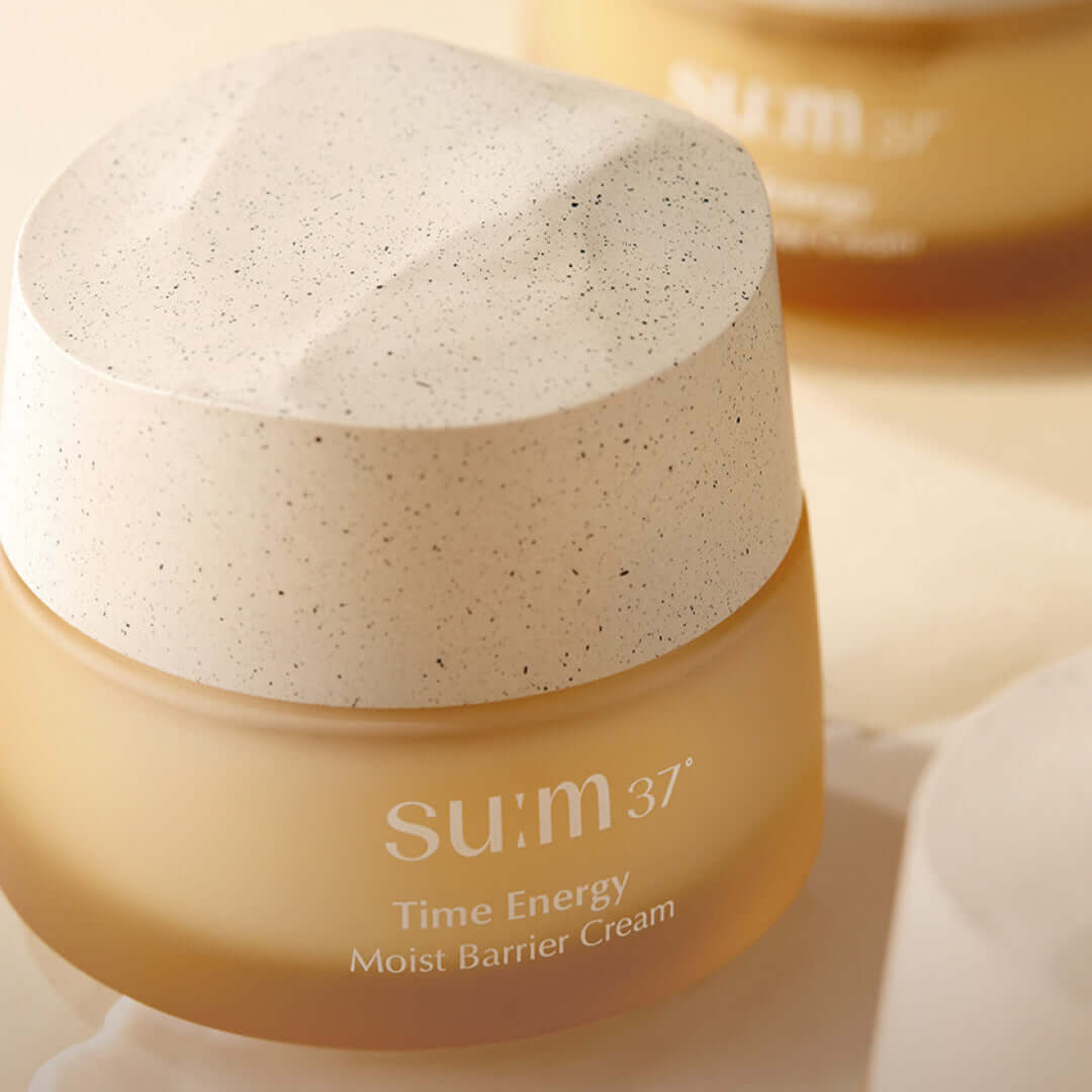 SU:M37 Time Energy Moist Barrier Cream 50ml in a beige jar with a textured lid on display, highlighting the luxurious skincare product.