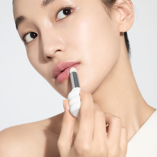 Woman applying Sulwhasoo Rose & Glowing Lip Balm to her lips for a radiant finish.