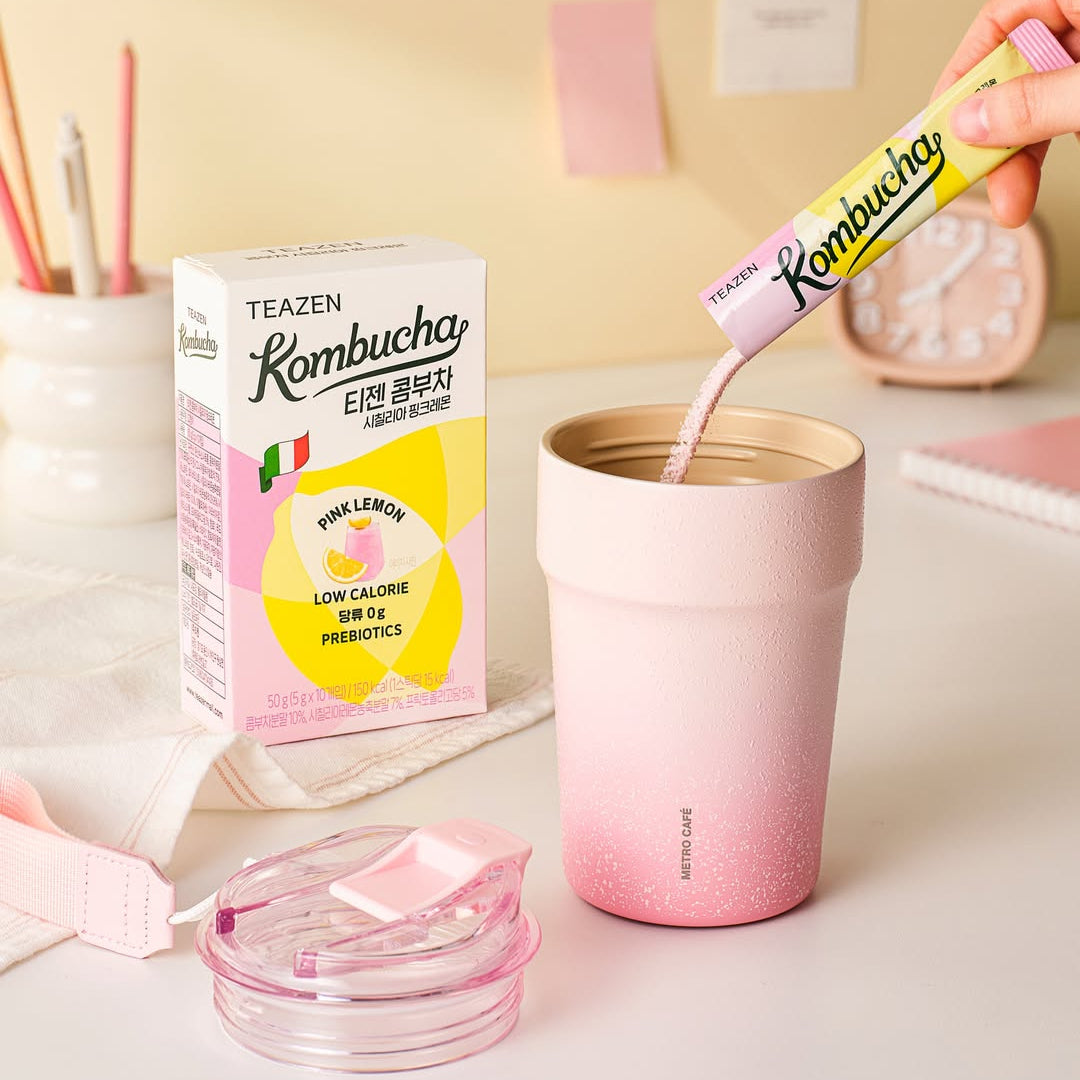 TEAZEN Kombucha Sicillian Pink Lemon 10 Sticks with pink cup and box on pastel background
